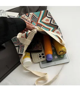 Detail shot showing large storage capacity of bohemian knit tote bag with personal items