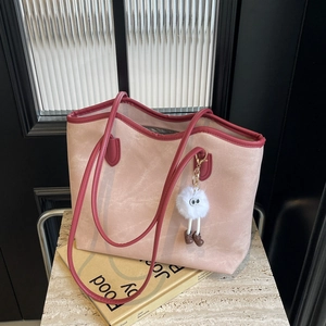 Chic pink oversized tote bag with burgundy trim, long straps and fuzzy monster charm