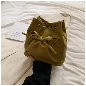 Detalle del bolso de cubo verde oliva con cordón lazo y correa de cadena