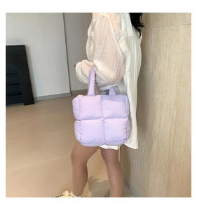 Detail of light purple quilted tote bag with padded texture and wide shoulder strap