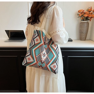 Detail of colorful geometric bohemian knit pattern on a large shoulder tote bag
