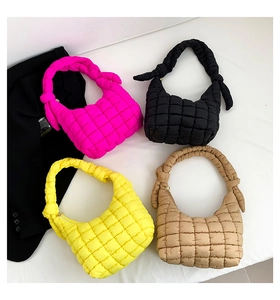 Detalle de textura acolchada de bolsos de nailon en rosa, negro, amarillo y caqui