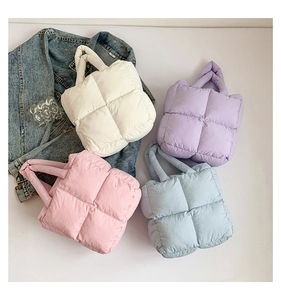Detailed display of quilted puffer bags in pearl white, lilac, pink and light blue colors
