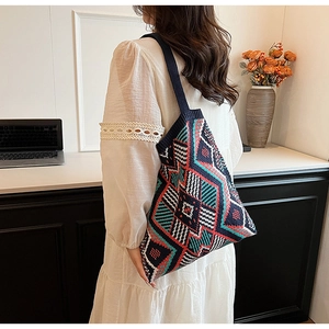 Detail view of ethnic geometric pattern on vintage knitted shoulder bag for women