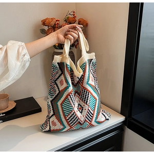 Close-up of bohemian knit tote bag showing intricate geometric patterns and thick handles
