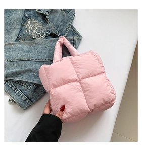 Detailed close-up of a pink quilted down cotton shoulder bag with a stylish puffy design