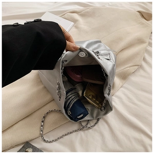 Vista interna del bolso cubo plateado con capacidad para móvil y paraguas