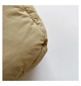 Macro texture view of windproof khaki quilted down material with soft satin finish