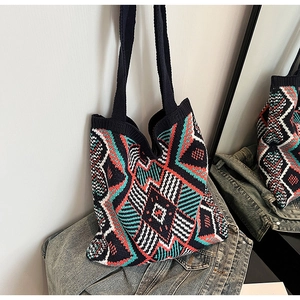 Macro detail of bohemian geometric knit tote bag with vibrant ethnic patterns
