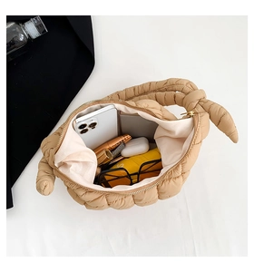 Top view of beige quilted puffy bag showing spacious interior with daily essentials