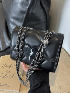 Quilted black crossbody bag with heart motif and adjustable chain strap for women
