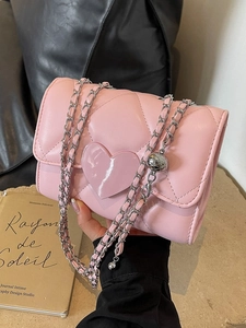 Pink quilted chain crossbody bag with heart motif and decorative metal ball