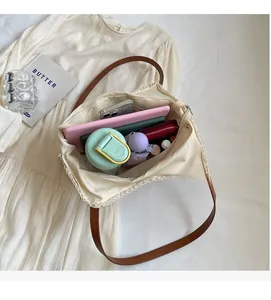 Top view of beige woven tote bag showing large capacity with daily items and brown strap