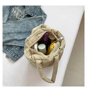 Top view of spacious beige quilted puffer bag showing interior storage capacity and lining