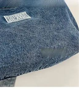 Close-up of blue denim tote bag texture featuring 7STREET 6LANE embroidered patch