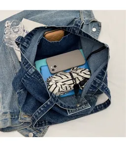 Spacious denim tote bag showing large capacity with tablet and daily essentials