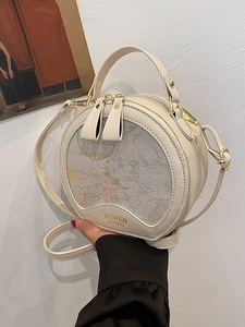 Cream round handbag with floral embroidery and adjustable strap by BOWEN EST.2023