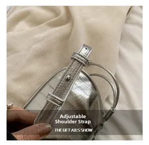 Detail of adjustable silver shoulder strap with metallic ball buckle on pleated cloud bag