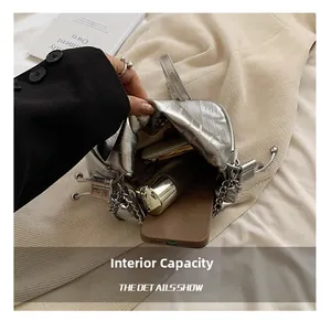 Macro view of silver pleated cloud bag showing interior capacity for phone and cosmetics