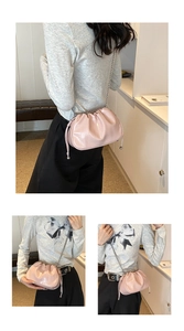 Detail of pink pleated cloud bag with metallic silver chain and drawstring accents