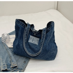 Minimalist dark blue denim tote bag with 7STREET 6LANE label on flat lay fabric