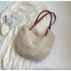 Chic woven tote bag with brown leather straps and cream hollow knit texture for women