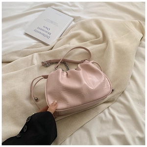 Detail of pink pleated cloud bag with metallic chain and MINIER embossed logo
