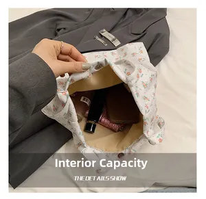 Detail view of the spacious inner compartment of the floral canvas tote bag with magnetic snap