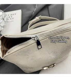 Detail showing smooth silver zipper and striped lining of creamy bucket bag
