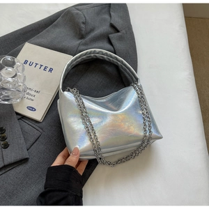 Detail of silver iridescent shoulder bag featuring dual metallic chains and soft leather folds