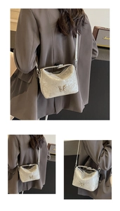 Detail view of silver glitter bucket bag with butterfly buckle and crossbody strap