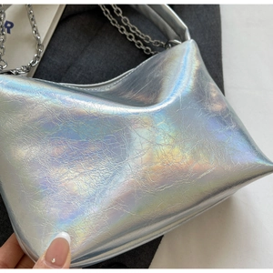 Macro shot of silver laser handbag texture with metallic iridescent pleated surface