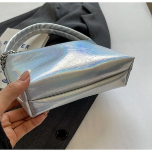Detail of silver holographic mini handbag showing pleated faux leather and metal chain