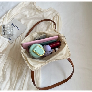Interior detail of large straw tote bag showing spacious storage for daily essentials