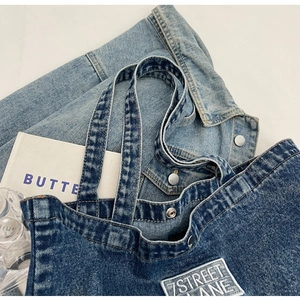 Close-up of deep blue denim tote bag texture with white 7STREET LANE embroidered label