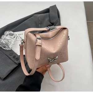 Detail of pink textured PU bag featuring a silver butterfly buckle and metallic finish