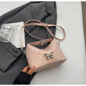 Close-up of pink marbled bucket bag with silver butterfly buckle on a grey blazer