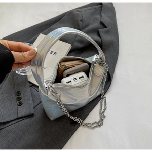 Detail view of the silver laser PU leather bag showing spacious interior for essentials