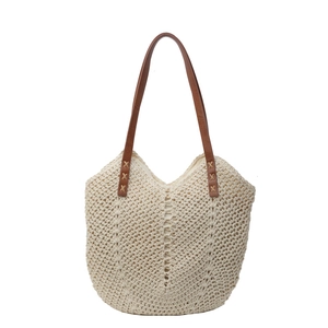 Cream crochet straw tote bag with brown faux leather straps for summer beach vacation