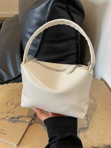 Chic beige crossbody bag with glossy pleated texture and silver chain strap