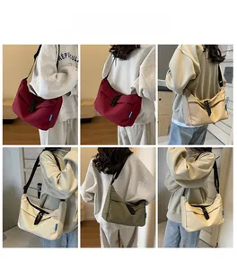 Detail view of large nylon dumpling bags in multiple colors with adjustable straps