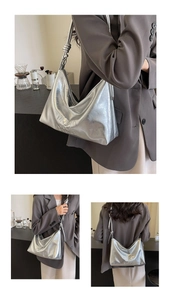 Detail of silver metallic tote bag with MUJUO COOL DESIGN embossing and knot strap