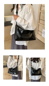 Detail of glossy black PU leather tote bag with embossed MUDUO logo and knotted shoulder strap