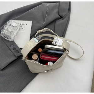 Internal view of beige crossbody bucket bag showing large capacity for essentials
