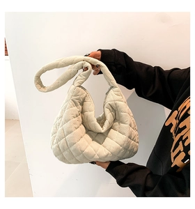 Detailansicht der beigen gesteppten Cord-Tragetasche mit weicher Textur und Gurt