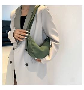 Detail of army green corduroy crescent bag showing fabric texture and wide strap