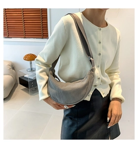 Detail of grey corduroy crescent bag showing soft ribbed texture and casual style