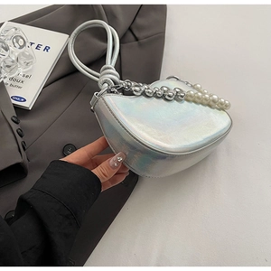 Close-up of holographic silver crossbody bag with pearl and metal chain detail