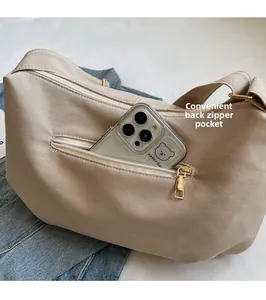 Detail of beige tote bag back zipper pocket showing easy storage for large smartphone
