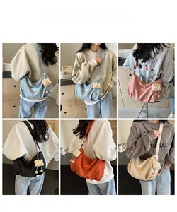 Large hobo tote bags with plush bear charms shown in five colors on models